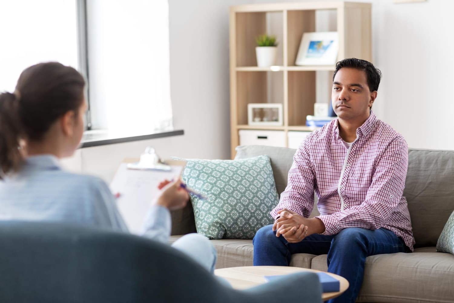 A therapist and client talk during a therapy session.