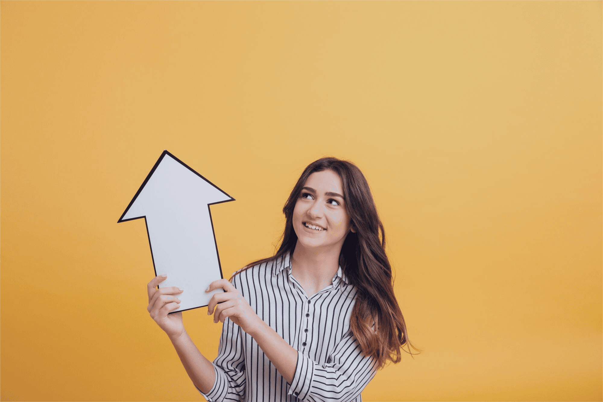 A person holding an arrow pointing upwards, signifying growth.