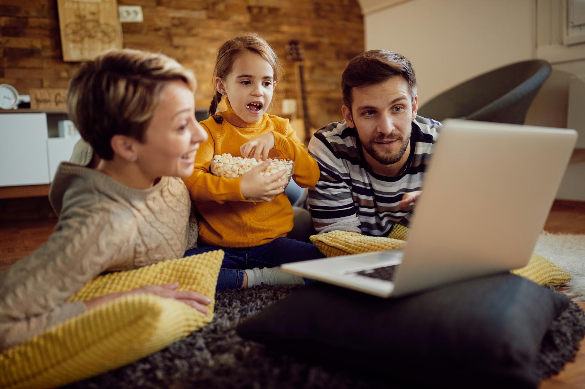 A kid watching a movie involving mental health themes with their parents.