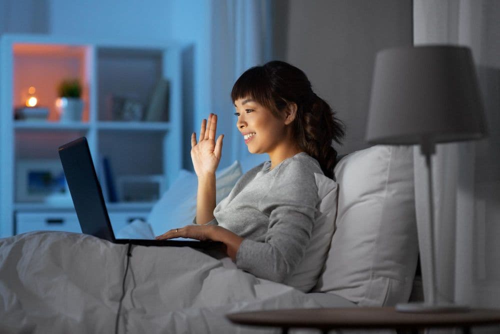 A person seeking online counselling for sleep issues from the comfort of their bed.  