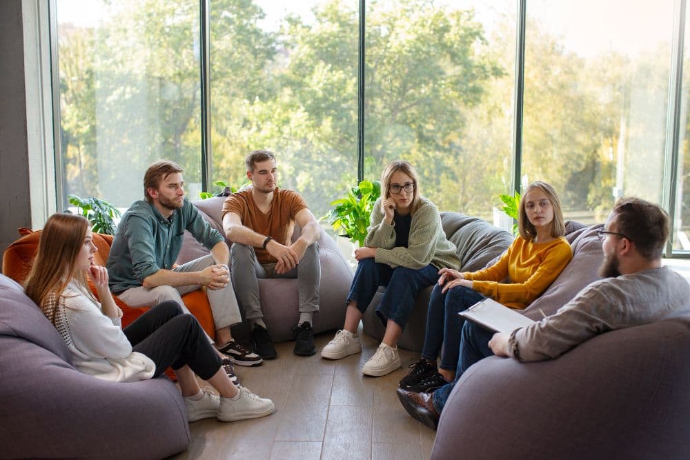 A group of people engaging in a group therapy session as part of counselling for social anxiety in Australia.