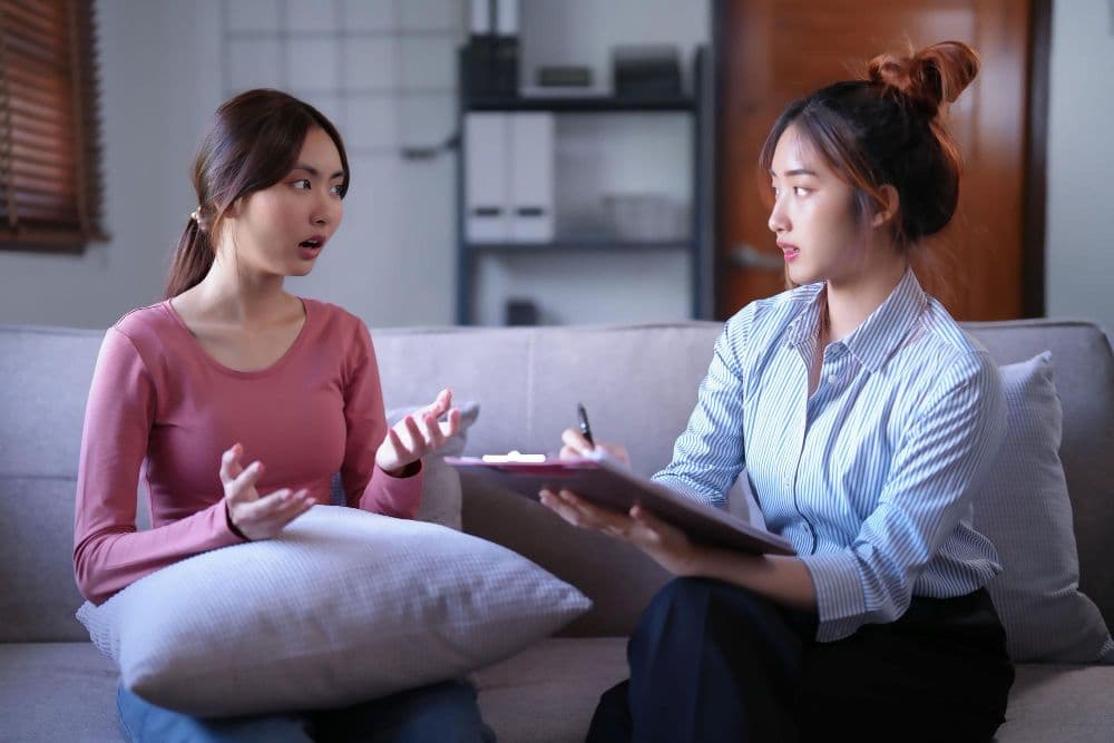 A psychologist in Singapore talking to a client about mental health issues