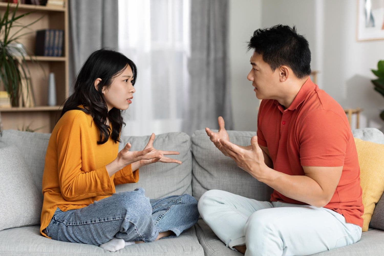 An Asian couple in the middle of an argument due to one partner's anger issues. This is one of the signs to consider anger management therapy in Singapore.
