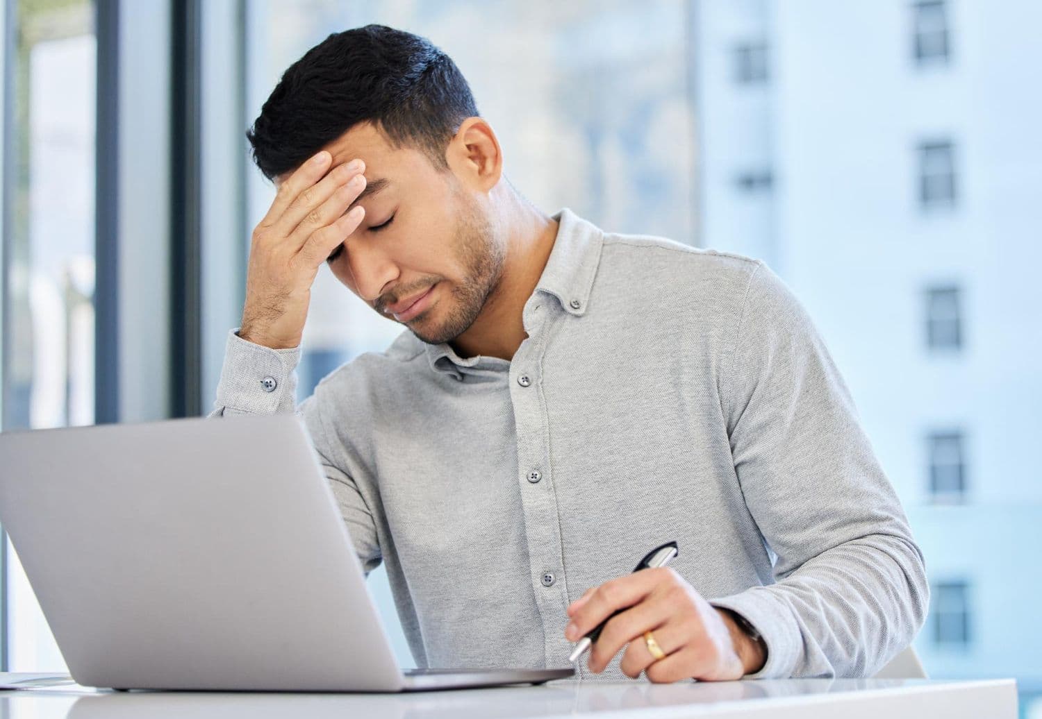 A person looking visibly stressed at work. A friend suggests that they try counselling for work stress.