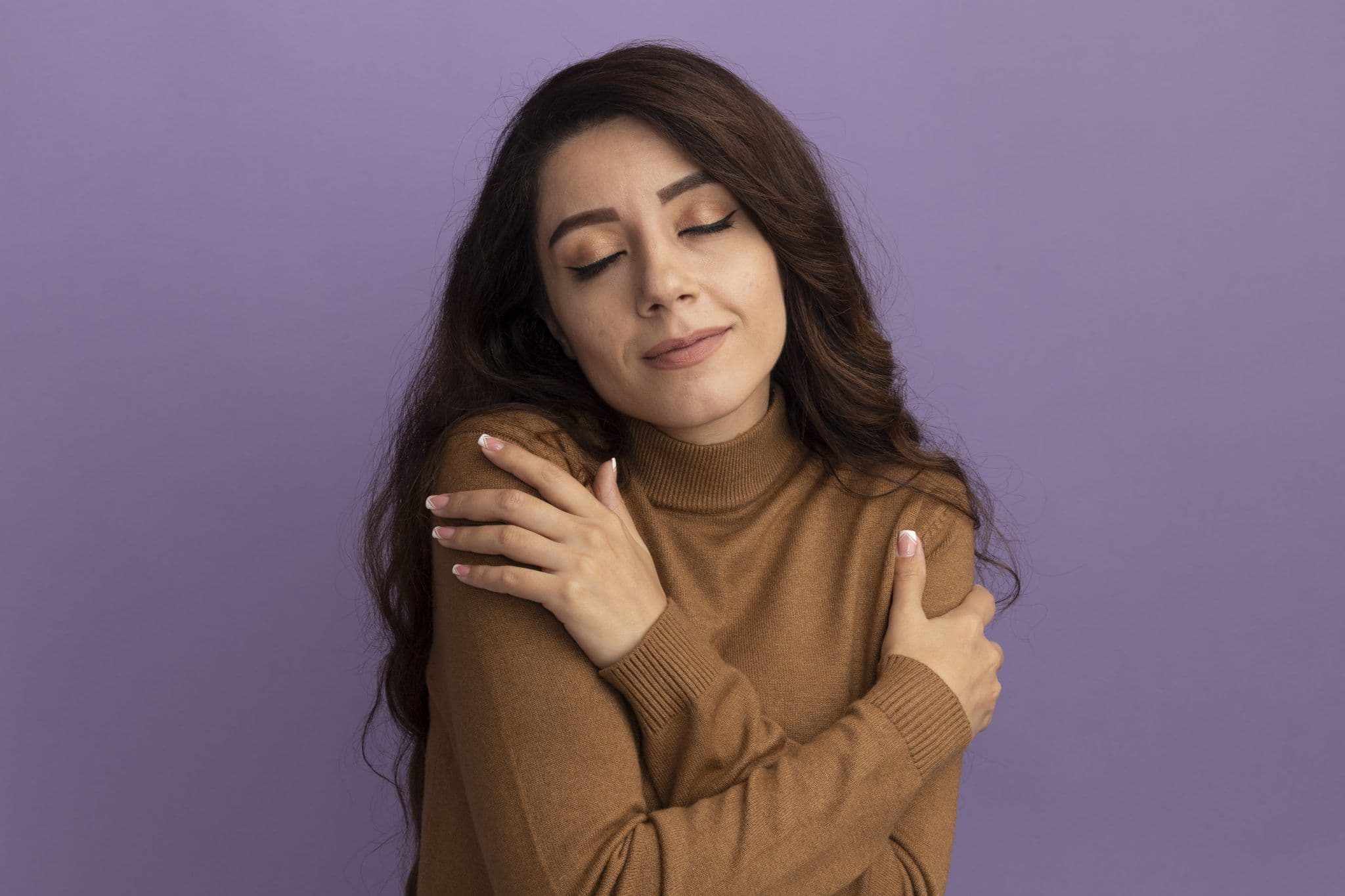 A person hugging themselves, showing self-compassion and personal development.
