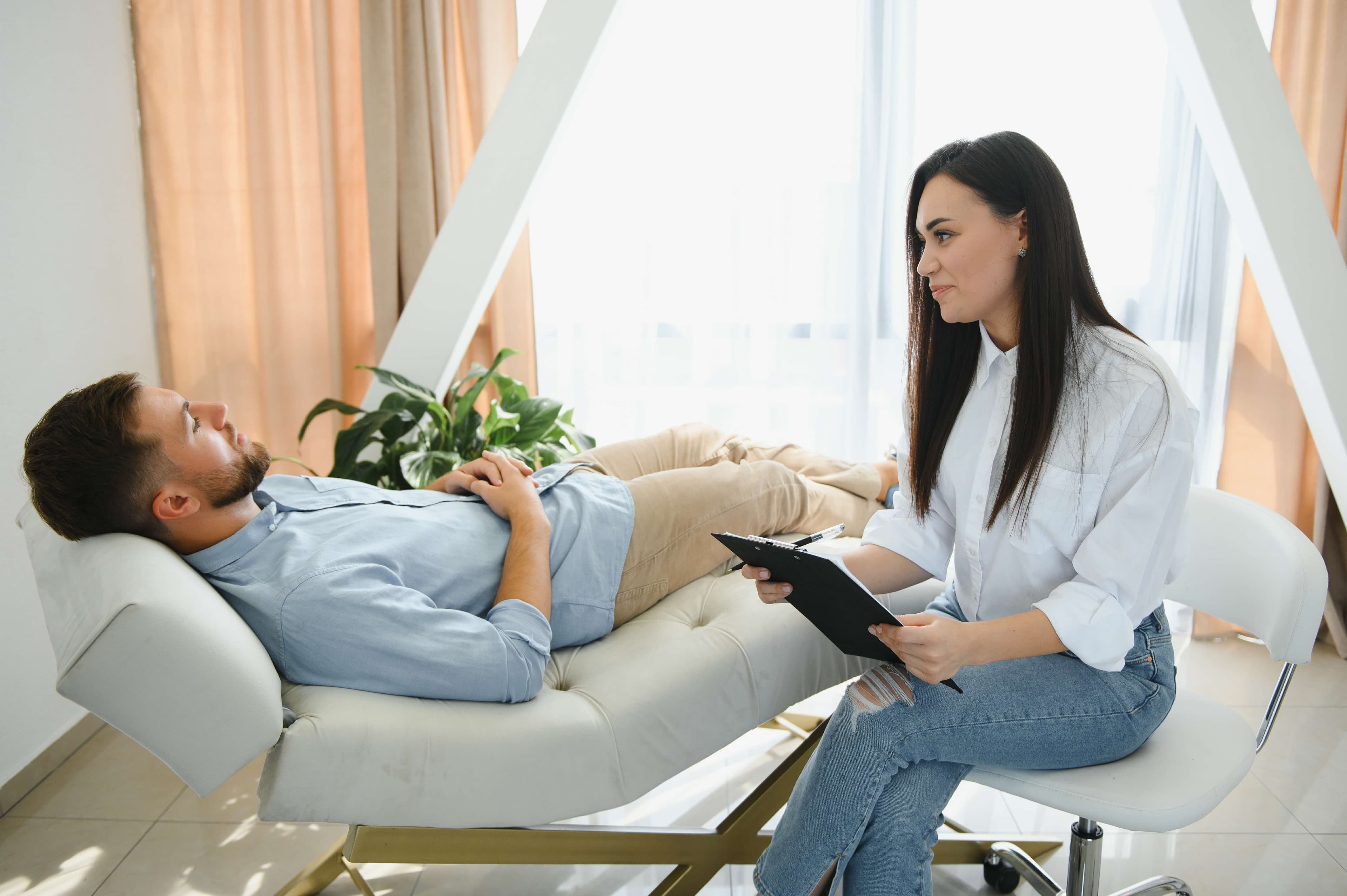 A therapist during a psychotherapy session explaining what therapy means