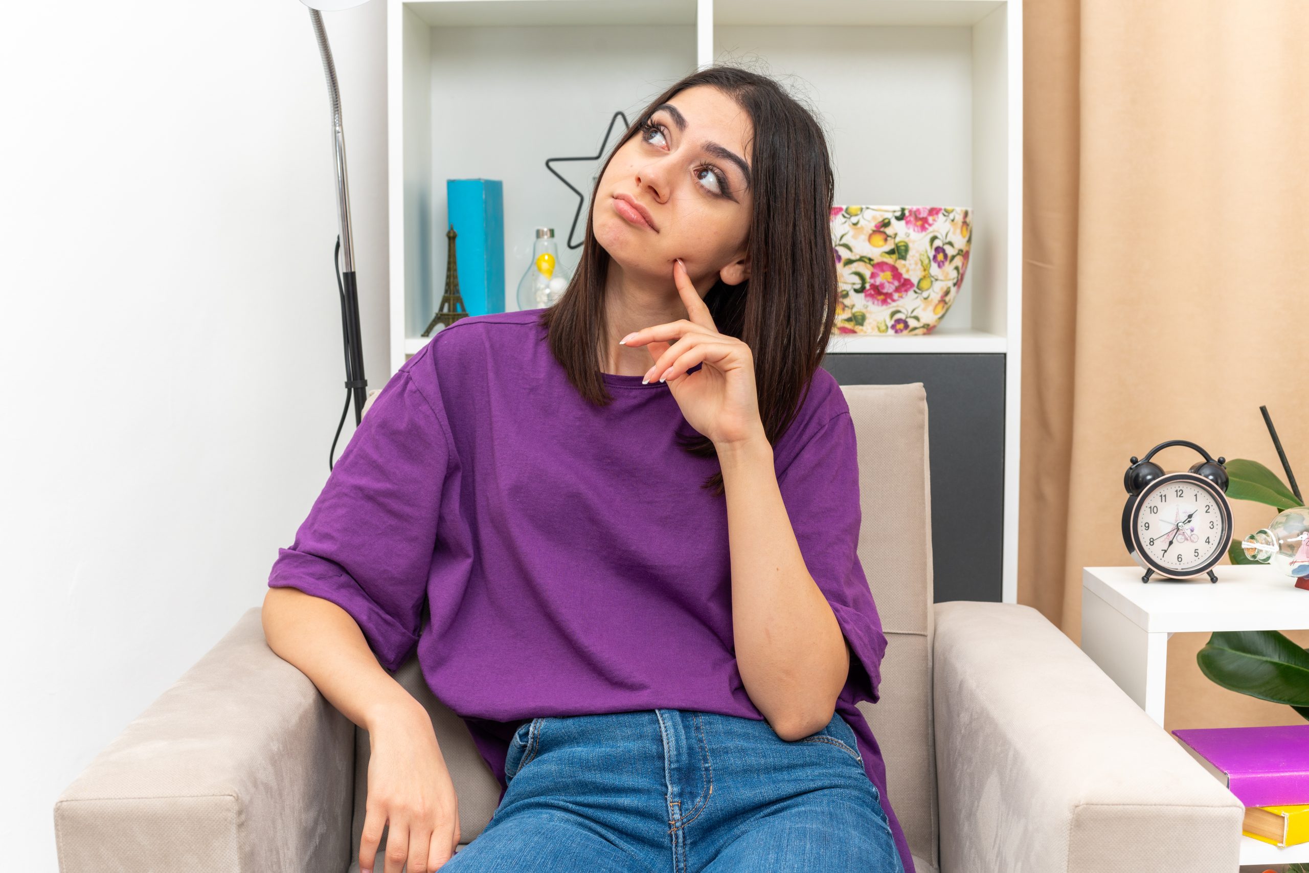 Online therapy Malaysia - A person sitting on a couch and thinking