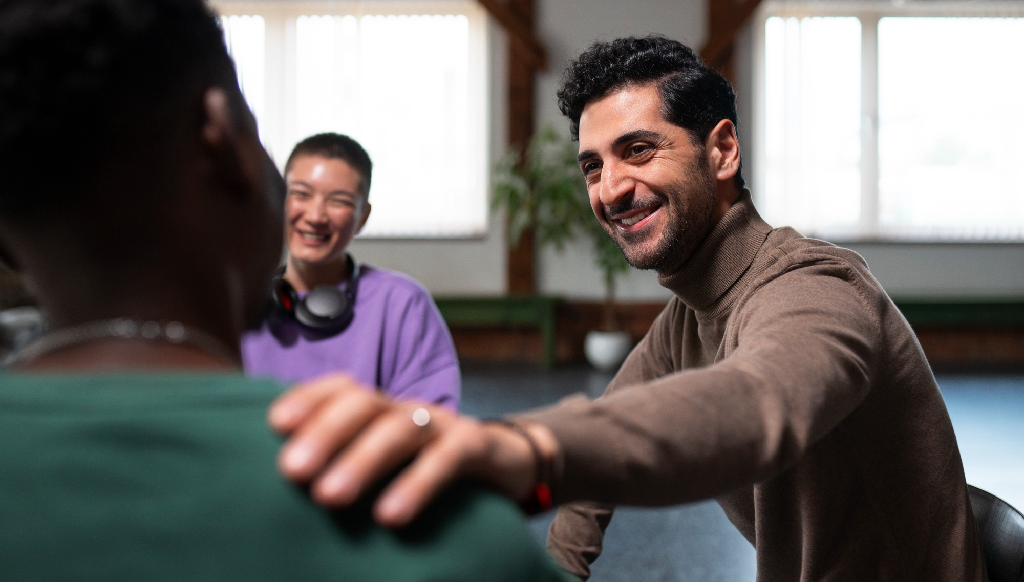 Employees suppoting each other in a office environment during job loss.